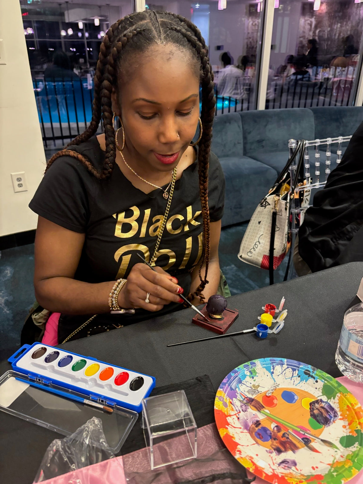 Wakita Doll, a member of The Black Doll Affair, painting her ME Doll at the first-ever member's ME Doll Group Sip & Paint Experience in Atlanta