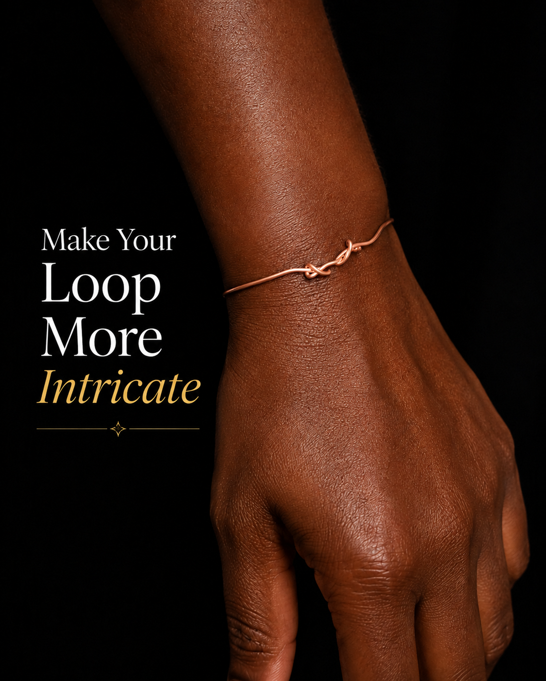 Close-up of the Melanin Copper Cuff with an intricate hand-designed wire loop on a dark-skinned wrist and the words "Make Your Loop More Intricate."