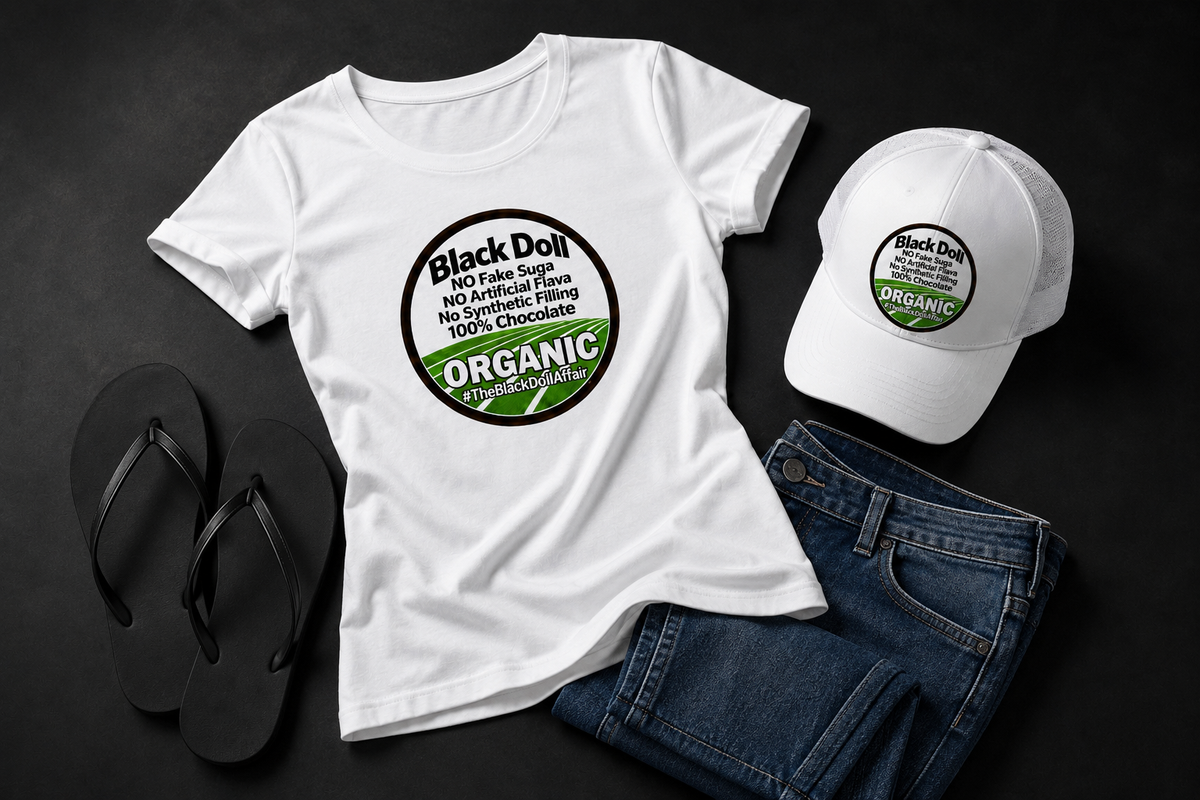 An editorial layout of The Black Doll Affair's 'Organic Original' white graphic T-shirt and matching five panel white trucker-style baseball cap that reads 'Black Doll' No fake suga, no artificial flava, no synthetic filling, 100% chocolate.' 'ORGANIC' on a black background paired with black flip-flops and blue jeans. 