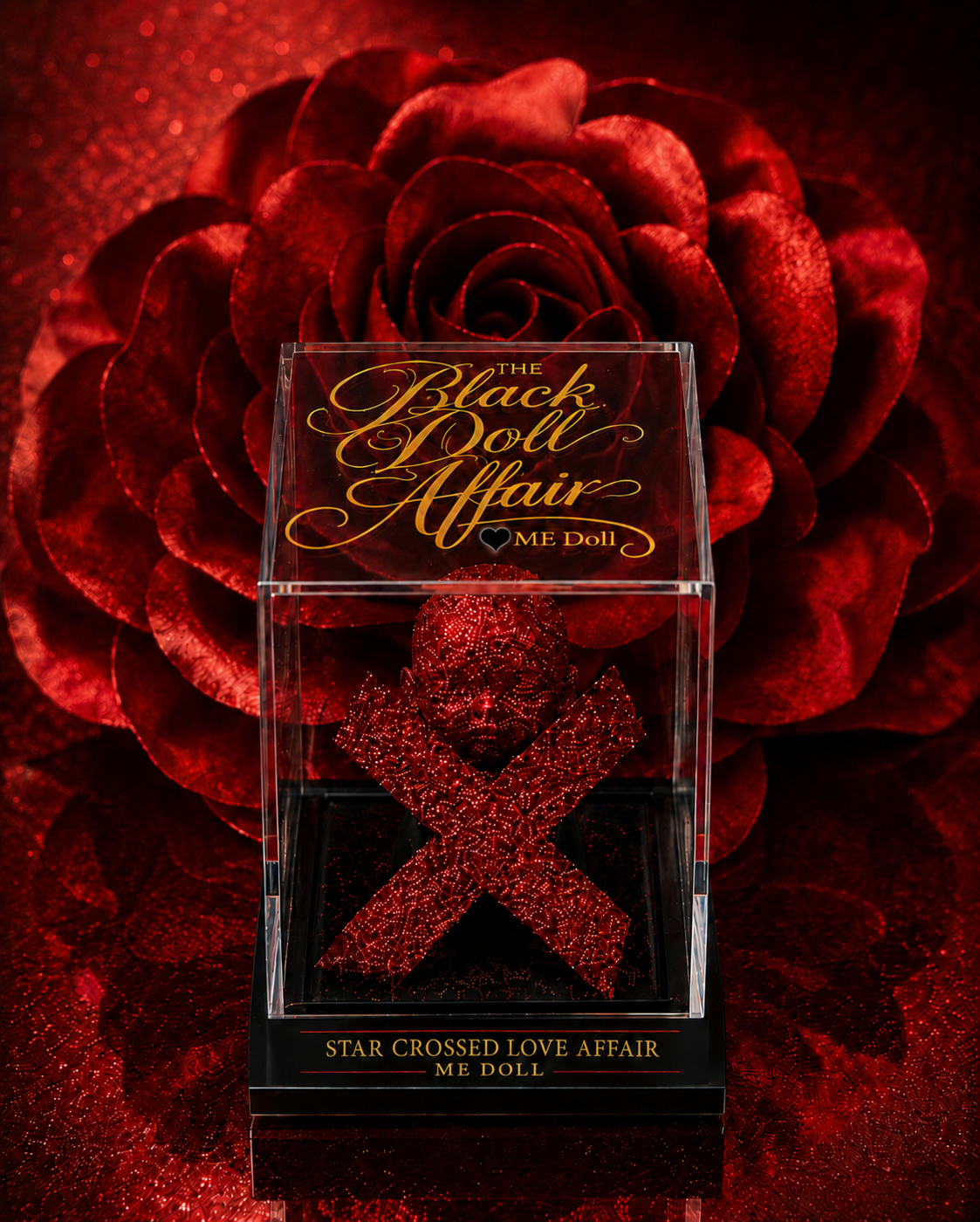 The Black Doll Affair Star Crossed Love Affair ME Doll on display with the gold logo script set against layered red roses backdrop, sitting on a black pedestal.